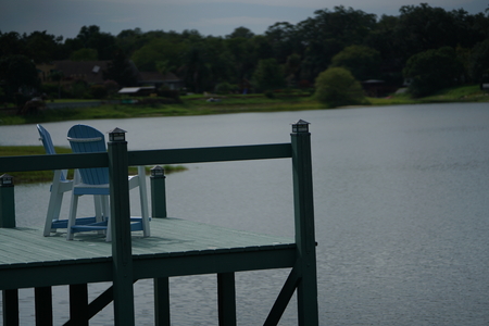 dock on a lake with chairsの写真素材