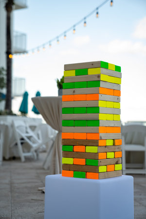 large wooden tile stacking game with many colors all over the pieces at an outdoor partyの写真素材