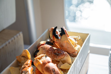 large platter of delicious and cracked stone crab claws at fine dining restaurant during the dayの写真素材