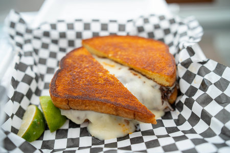 amazing grilled cheese sandwich with birria steak and limes at mexican food truckの写真素材