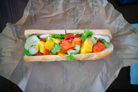 delicious latin inspired sub with meats, cheeses, fruits, and vegetables during lunch at latin deli