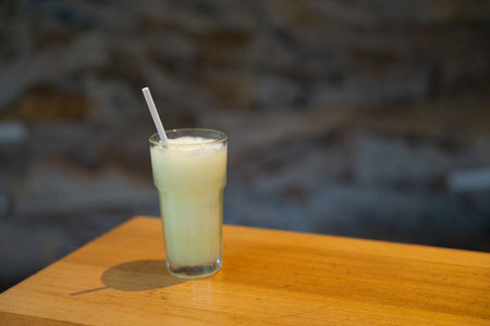 wide capture of frozen lime drink or margarita at restaurant during the dayの写真素材