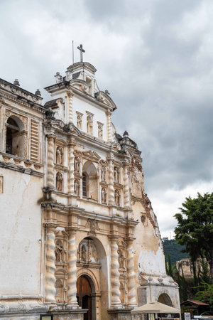 beautiful vertical wide capture of white facade church preserved ruins in spanish colonial town during cloudy dayの写真素材
