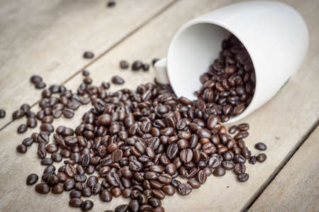 Coffee bean with Cup on wood table.の写真素材