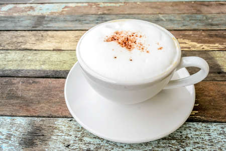 coffee in a white cup on wooden backgroundの写真素材