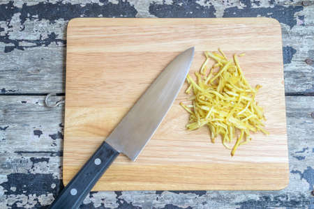 Ginger and Knife on wooden cutting boardの写真素材