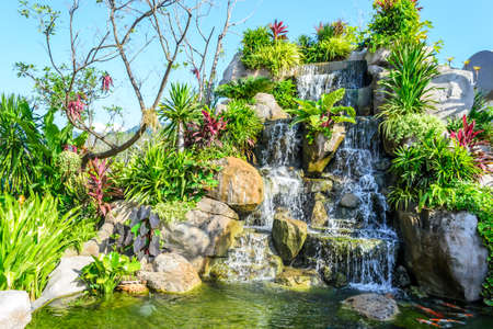 small waterfall in tropical gardenの写真素材