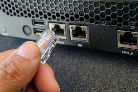 plug in LAN cable in network switchの写真素材