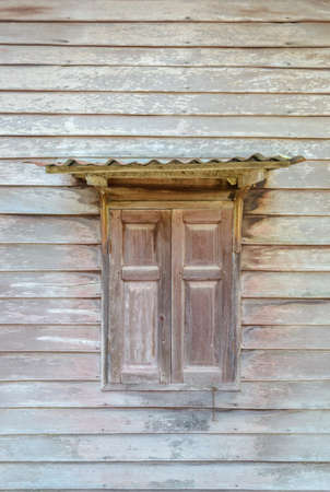 old windows at wooden houseの写真素材