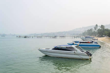 Speed Boats moored on tropical sea in Samui Island,Thailand with foggy sky.の写真素材