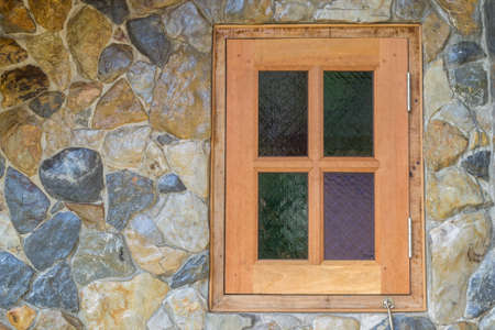 Wooden Window in the stone wallの写真素材