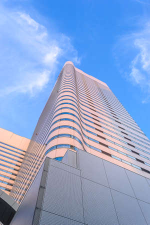 Perspective and underside angle view to modern building with blue sky backgroundのeditorial素材
