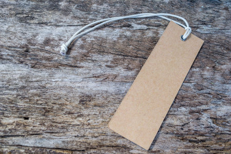 Blank tag tied. Price tag, gift tag, sale tag, address label on old wood background