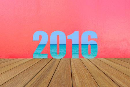 Happy New Year 2016 word created text from the sea picture on wood