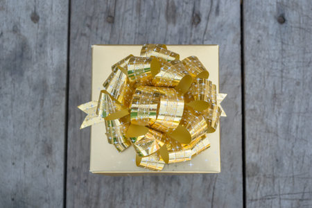 Gift box gold on vintage wooden board.の写真素材