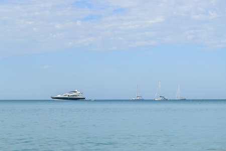 Boat and sailing boat at Layan Beach, Phuket Thailand with blue sky background