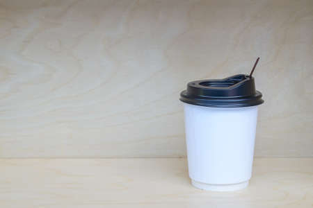 Paper coffee cup on wooden backgroundの写真素材