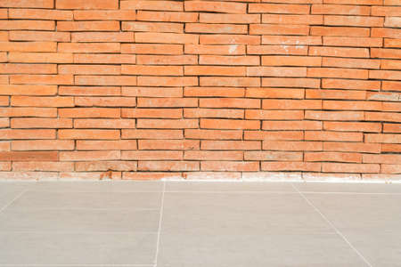 Tiled floor with bricks wall texture backgroundの写真素材