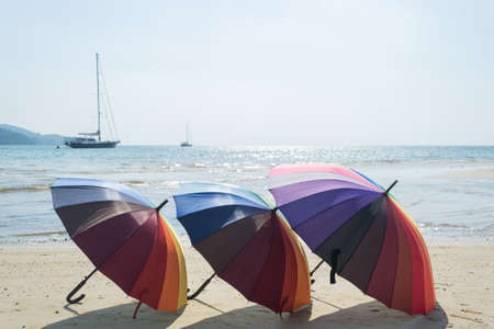 colorful of beach umbrella with sky and beach backgroundの写真素材