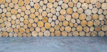 Wood log pile background with cement floorの写真素材