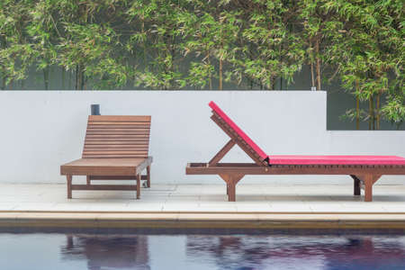 Wooden benchs beside the swimming poolの写真素材