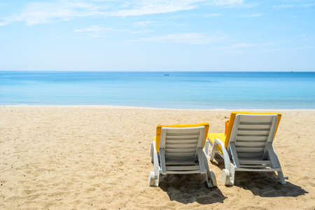 Two Beach chairs on White Sand Beach with blue sky in Phuket,Thailandの写真素材