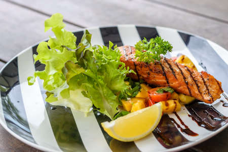 Grilled Salmon with lemon and mango. Selective focusの写真素材