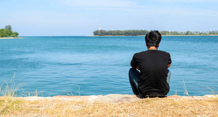 young man in relaxing on beachの写真素材