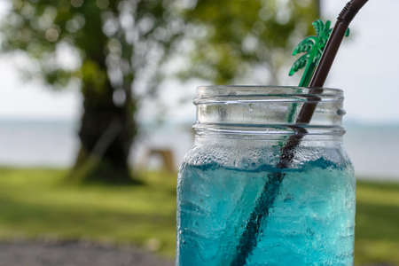 blue lemon soda with blur beach backgroundの写真素材