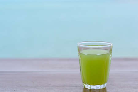 guava Juice on wood table with blur water sea background.の写真素材