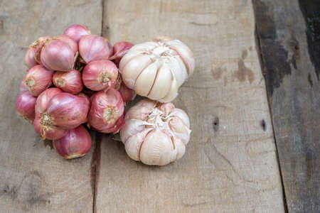 Onion and garlic on wooden tableの写真素材
