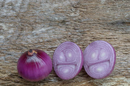 Sliced fresh purple onion isolated on wooden backgroundの写真素材