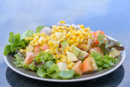 Salad on the plate on a marble tableの写真素材