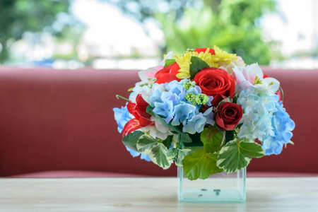 Colorful decoration beautiful artificial flower on wood table.の写真素材