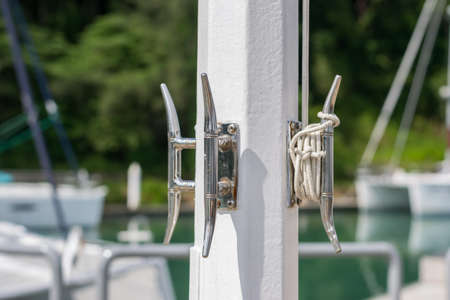 rope with a knotted end tied around a cleat at pierの写真素材