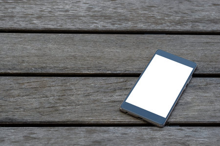 smartphone on the wooden texture backgroundの写真素材