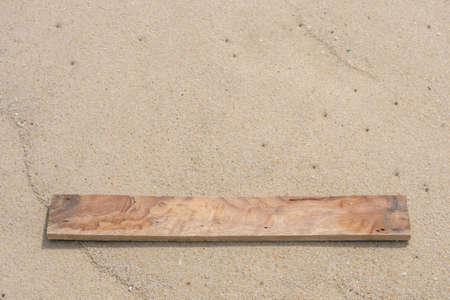 wood plate on sand beach backgroundの写真素材