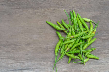 Close up of green chilli on wood backgroundの写真素材