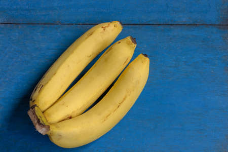 Bananas on the blue vintage wooden background for Healthy concept.の写真素材