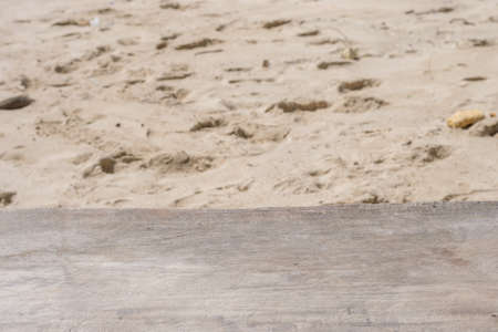 Wooden table top and white sand beach backgroundの写真素材