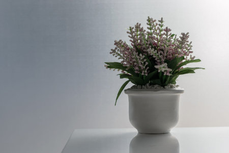 Vase of decorative flowers on the white table