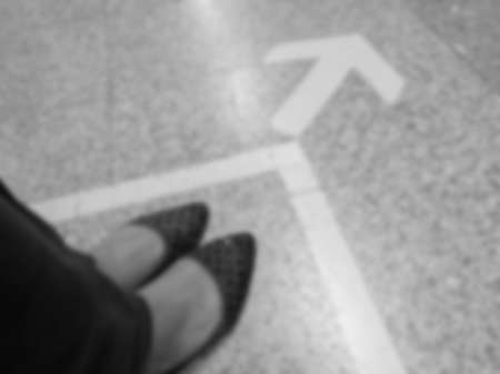 abstract blurred of women shoes with Arrow sign on floor at the subway station, bangkok, Thailand ,black and white conceptの写真素材