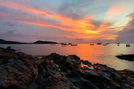 sunset on the beach at kalim bay in phuket thailandの写真素材