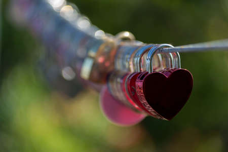 Red Lock in hart shape on rope bridgeの写真素材