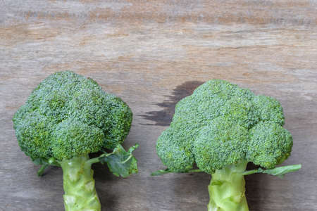 Two Fresh green broccoli on wooden backgroundの写真素材