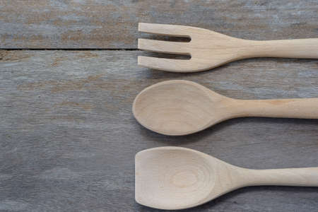 wooden spoon and fork and ladle on the old backgroundの写真素材