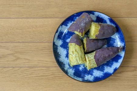 Purple sweet potato on wood backgroundの写真素材