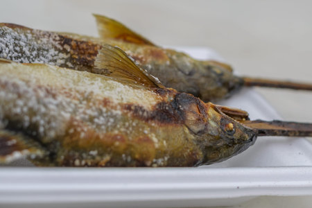 Close up of Grilled trout fish on wooden table at Kegon Waterfall, Nikko, Tochigi, Japan.の写真素材