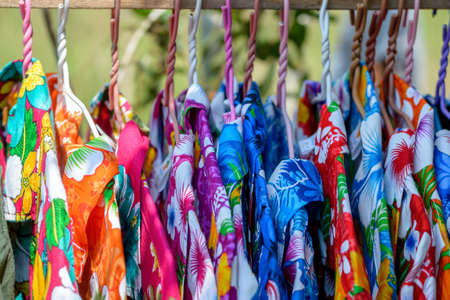Bright colorful shirt for summer on wooden hangers.の写真素材
