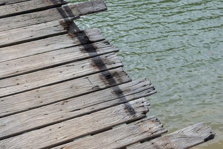 Close up of the old wooden pier in Thailand with copy space.の写真素材